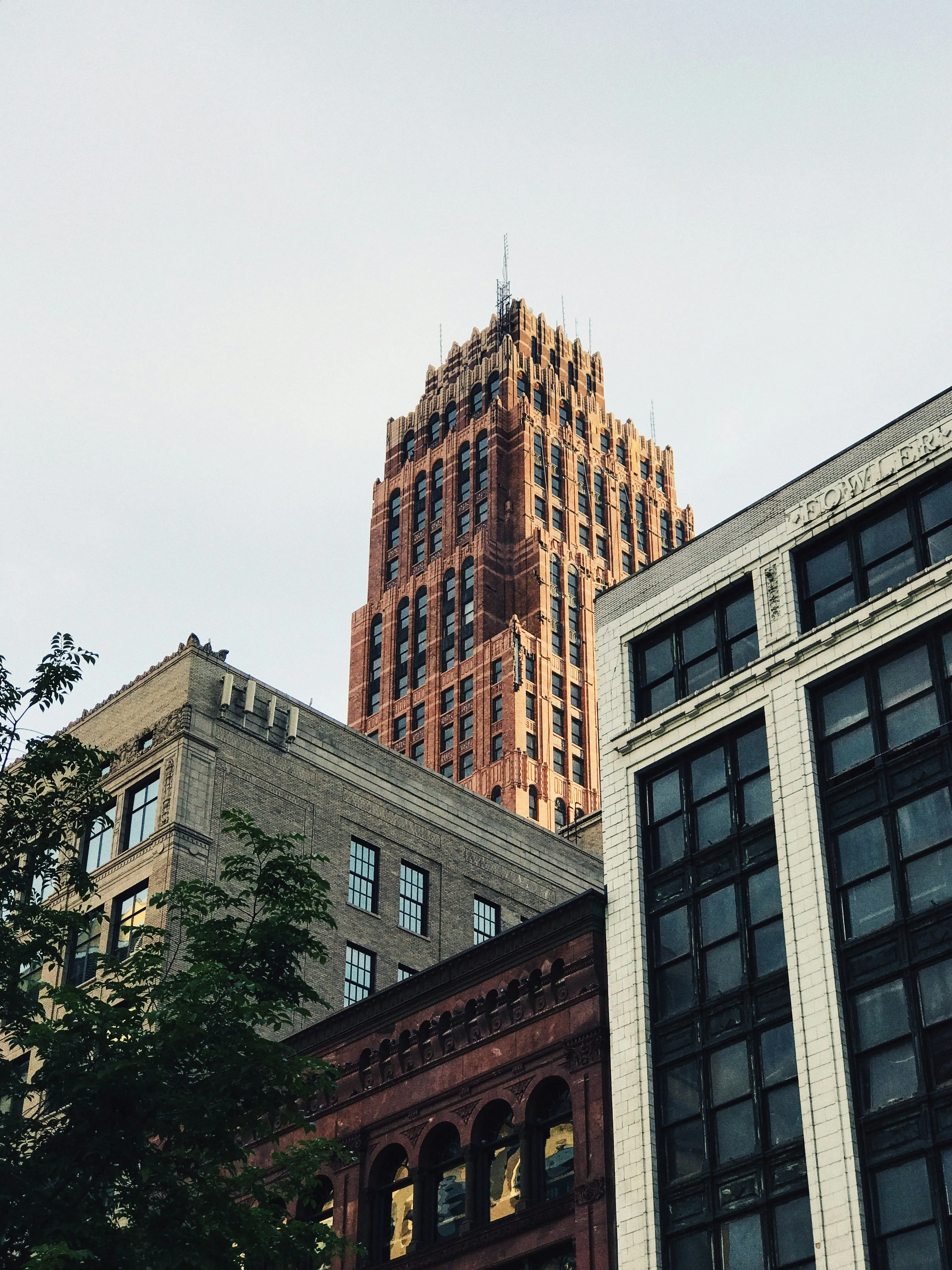 La corona del Guardian Building asomando sobre los edificios del centro de Detroit, vista desde la calle